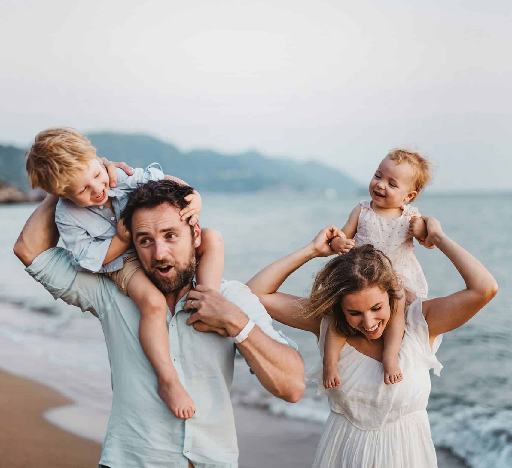 Family at the beach with children, happy and bonding outdoors.