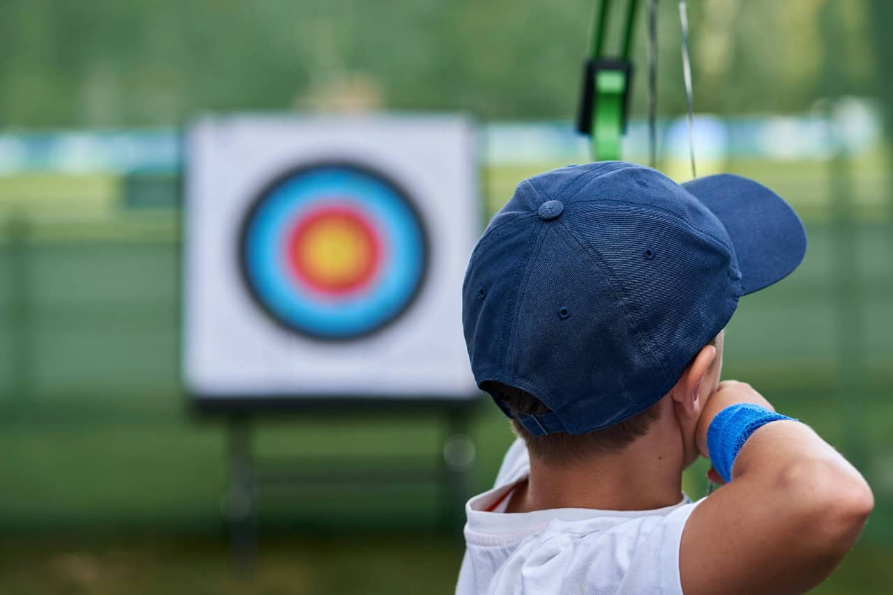 Child about to shoot an arrow at a target